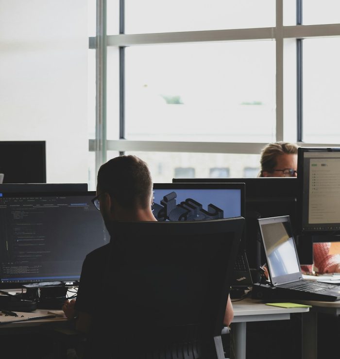 people sitting on chair in front of computer monitor